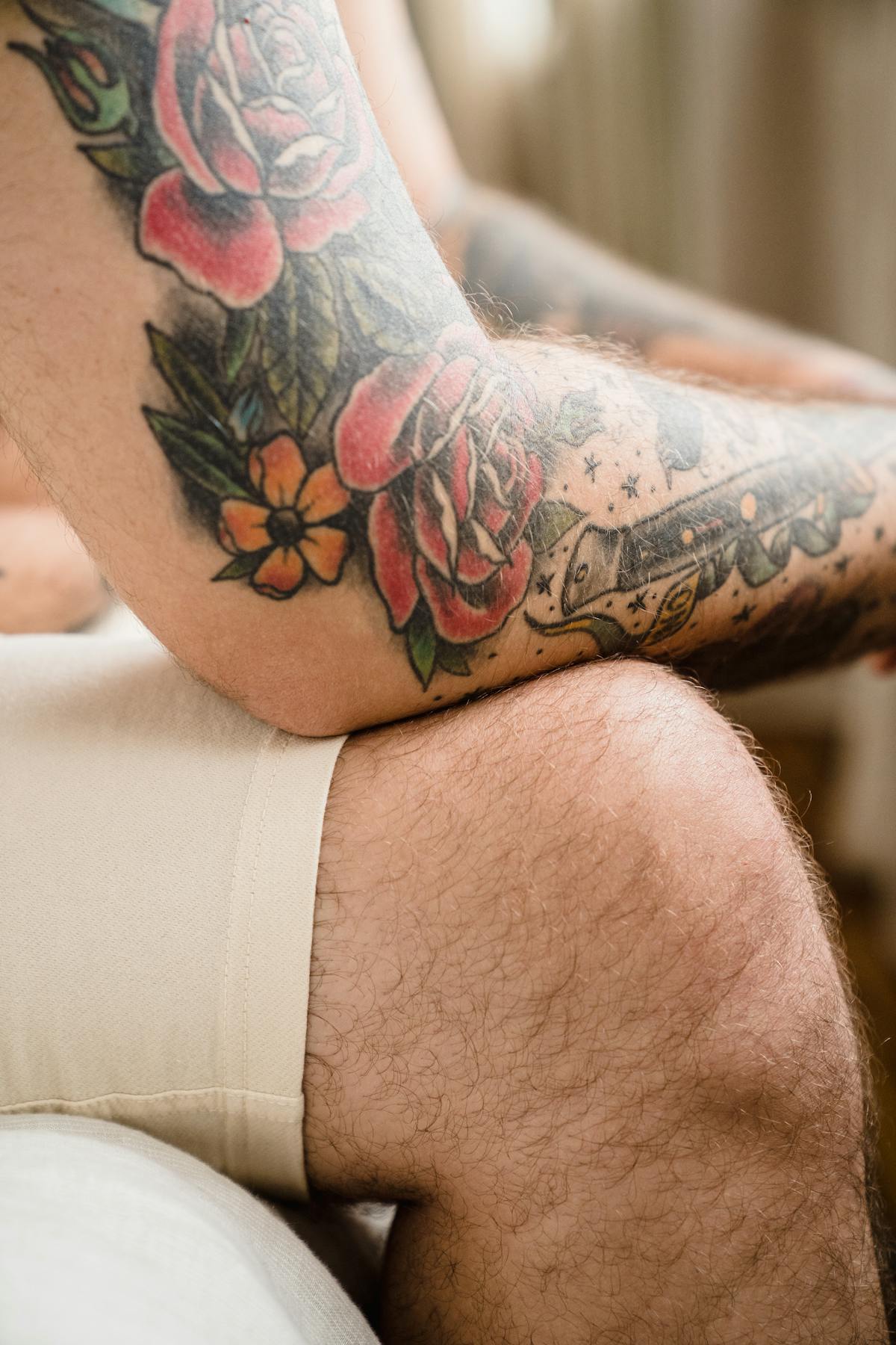 Floral sleeve tattoo in development across the arm