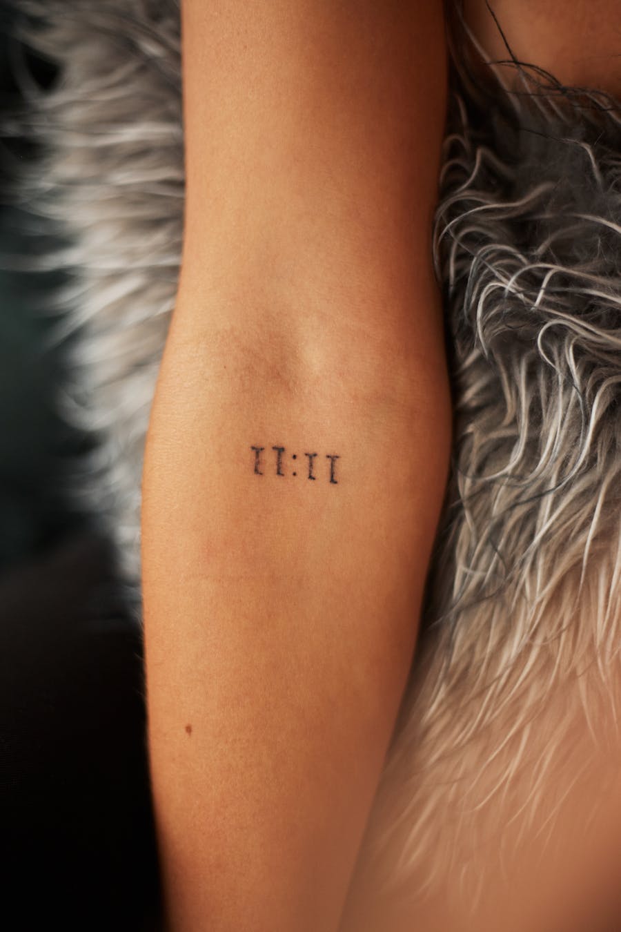 Minimal numerals tattoo on arm